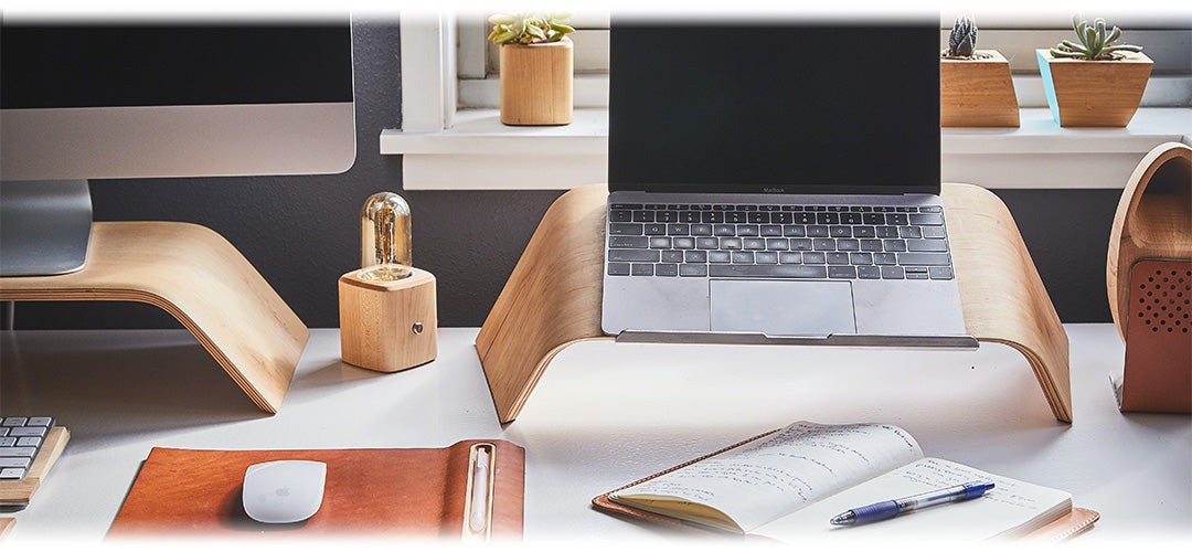 A home office setup with a desk, chair, computer, and stationery items.