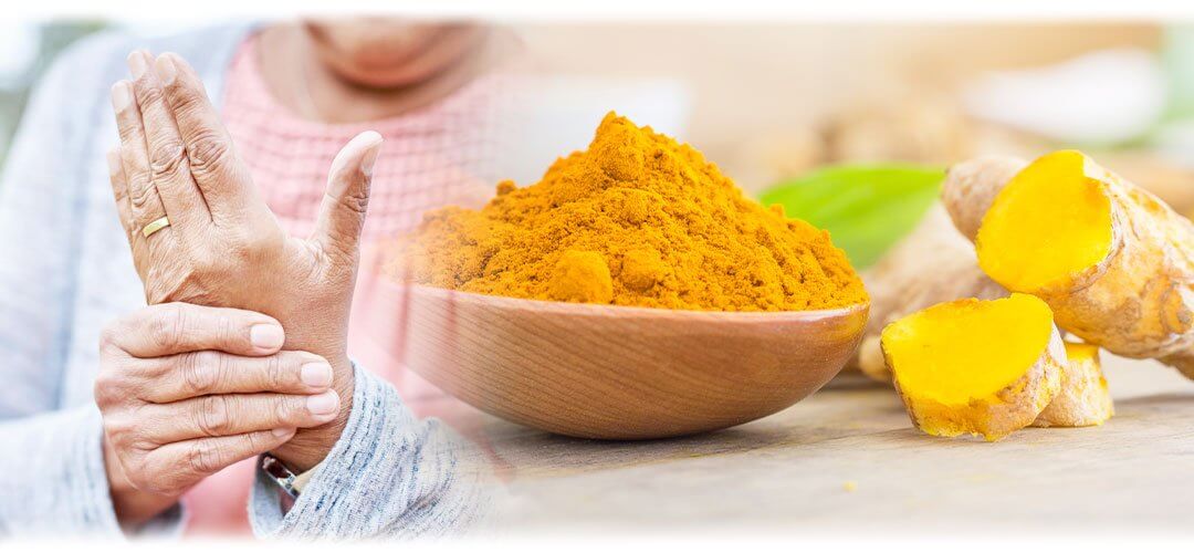 An image displaying a person rubbing their hand alongside a background of turmeric powder in a bowl. The image suggests the topic of using turmeric for arthritis management.