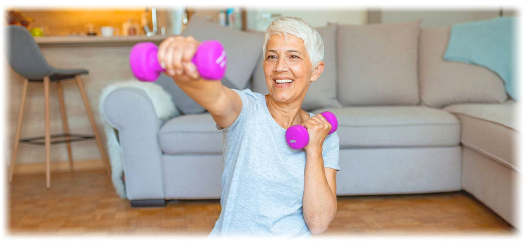 Smiling senior woman exercising with dumbbells, promoting fitness with Lily & Loaf's health support.