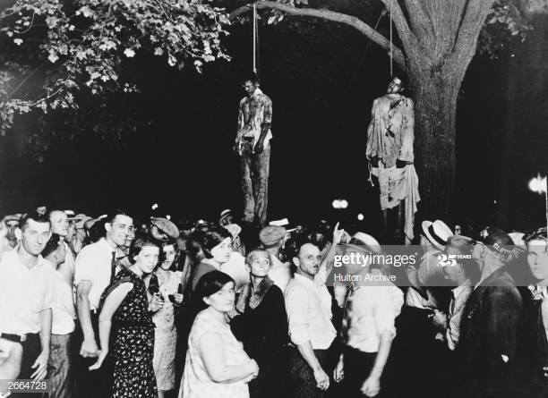 lynching of two men with edomites smiling and pointing