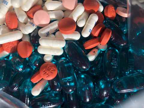 Photo of various medications and vitamins grouped together