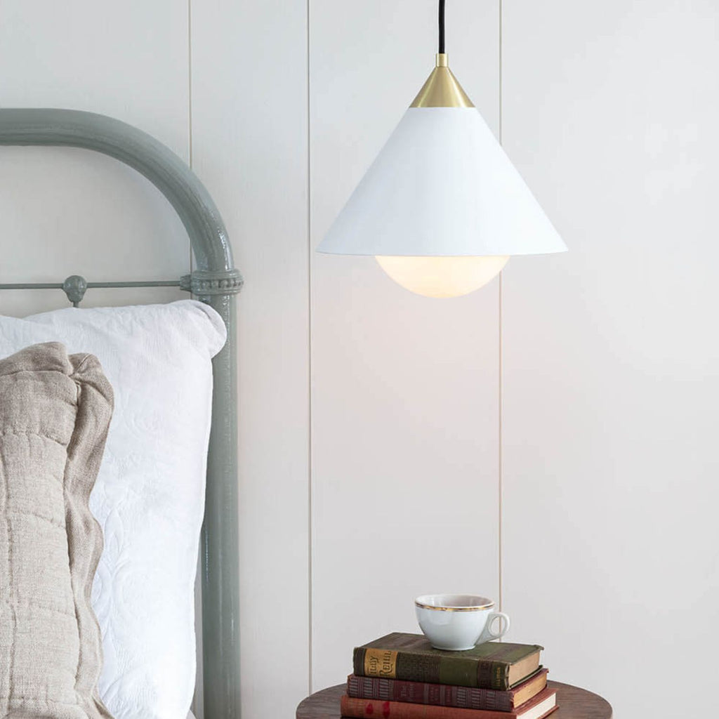 White cone pendant with brass detailing and black cord