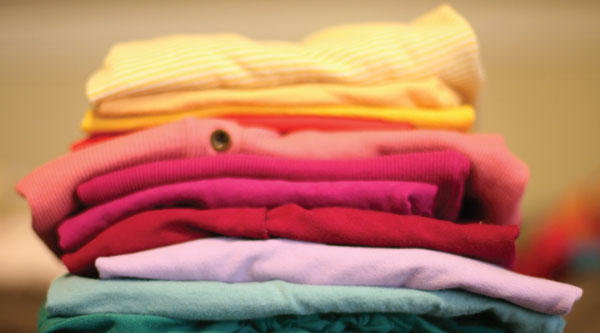 Folded clothing Photo Courtesy of @AGKrejci Pixabay