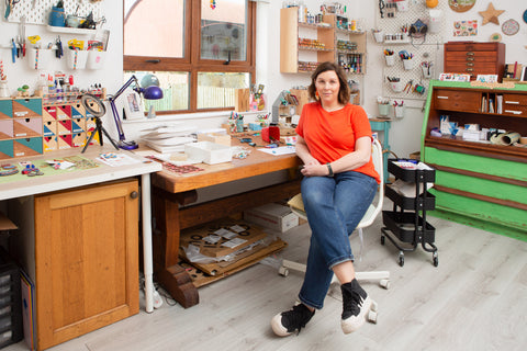 maura sitting at her studio desk