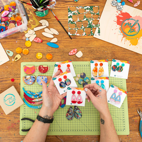 table showing paints, tools and jewellery items