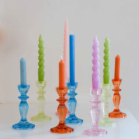 spiral dinner candles in bright lilac pink blue green orange colours in boho glass holders