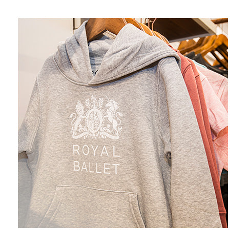 A close up of a grey hoodie with the Royal Ballet crest in white.