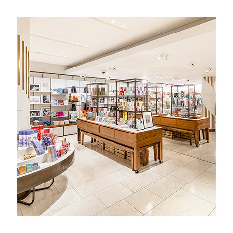 An empty shop floor with wooden display cabinets.