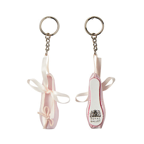 A pink ballet shoe keyring with the Royal Ballet crest printed on the sole against a white background.
