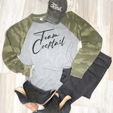 Camo sweatshirt paired with heels and black jeans