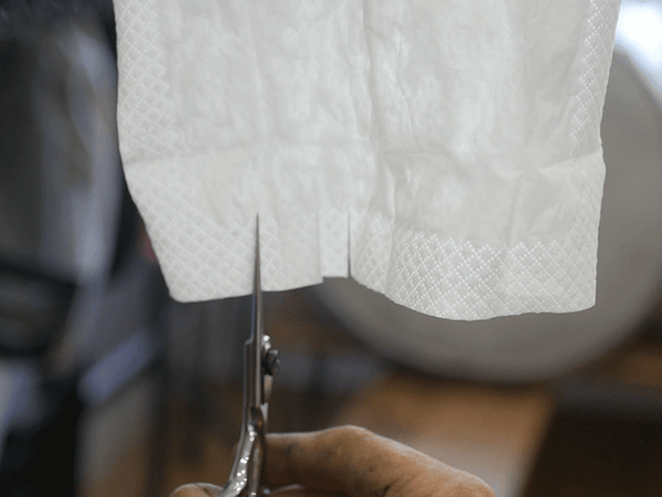 Tissue paper being cut with sharpened scissors