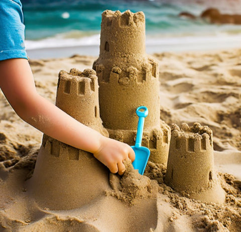 little hands building sandcastles on the beach