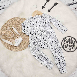 black and white baby romper with paint splatter effect by bayridgecaskandkeg