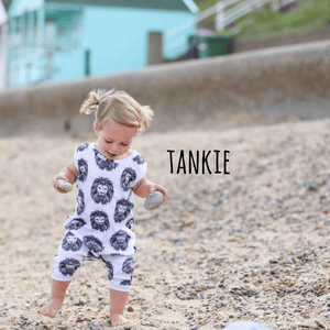 Toddler girl wearing  a lottie and lysh tankie style zipless romper in aztec lion