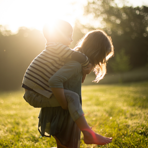 Two children playing in a garden for the feature images of Child-Safe Fencing