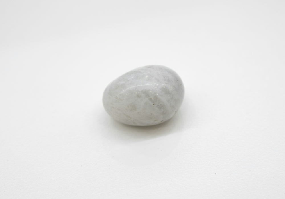 A white moonstone on a blank white background for definition