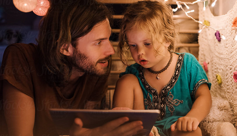 Father watching movie with child