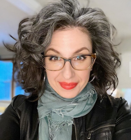 Woman with dark brown and grey wavy hair