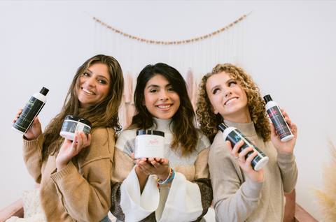 Three young women holding MopTop Hair Products