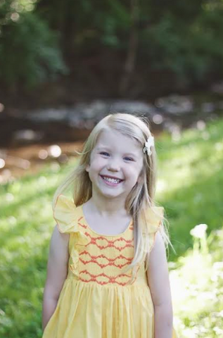 Savannah: a real ray of sunshine in her Yellow Netti Dress and her baby sister Caroline looking like a blooming rose in her fuschia pink Netti dress 