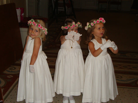 Darling flower girls in handmade white smocked dresses for a chic wedding in France 