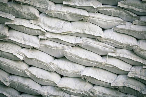 A stack of white sandbags used for flood control