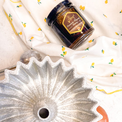 Bundt cake tin with honey haven jar of honey in background