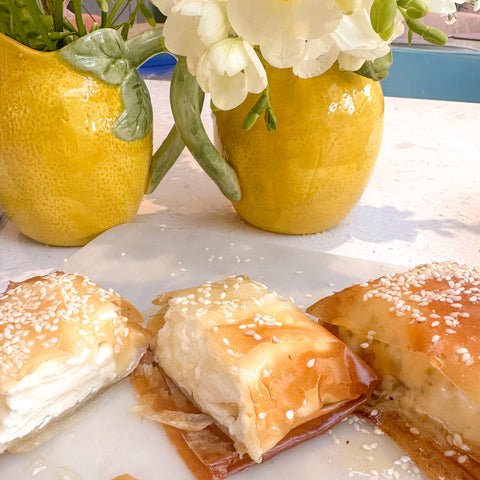 filo feta parcels cut open on kitchen work top with flowers in background