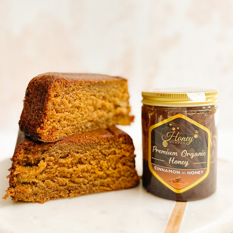 Honey and banana cake sliced by a jar of cinnamon honey 