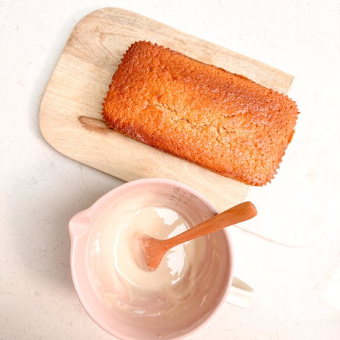 Cooked cake load with icing in a pink jug  