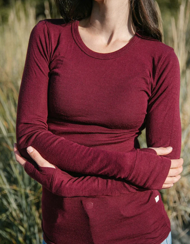 Woman wearing red natural fiber long-sleeve shirt.