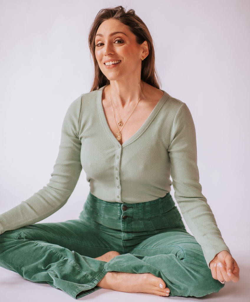 woman sitting cross legged and smiling