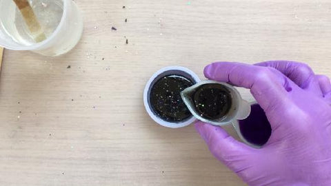 pouring black resin mix into silicone mold