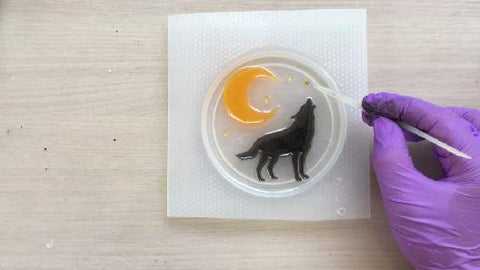 placing wolf and crescent moon into coaster mold