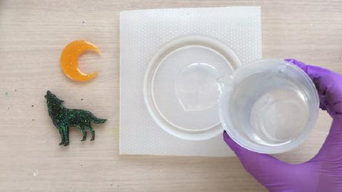 pouring clear resin into coaster plastic mold