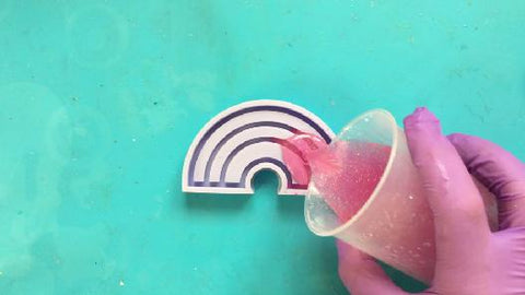 pouring resin into rainbow silicone mold