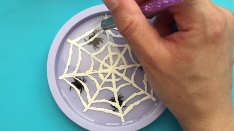 Hand painting cobweb into cured resin