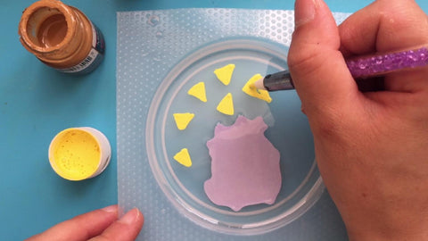 painting pizza slices with yellow paint 