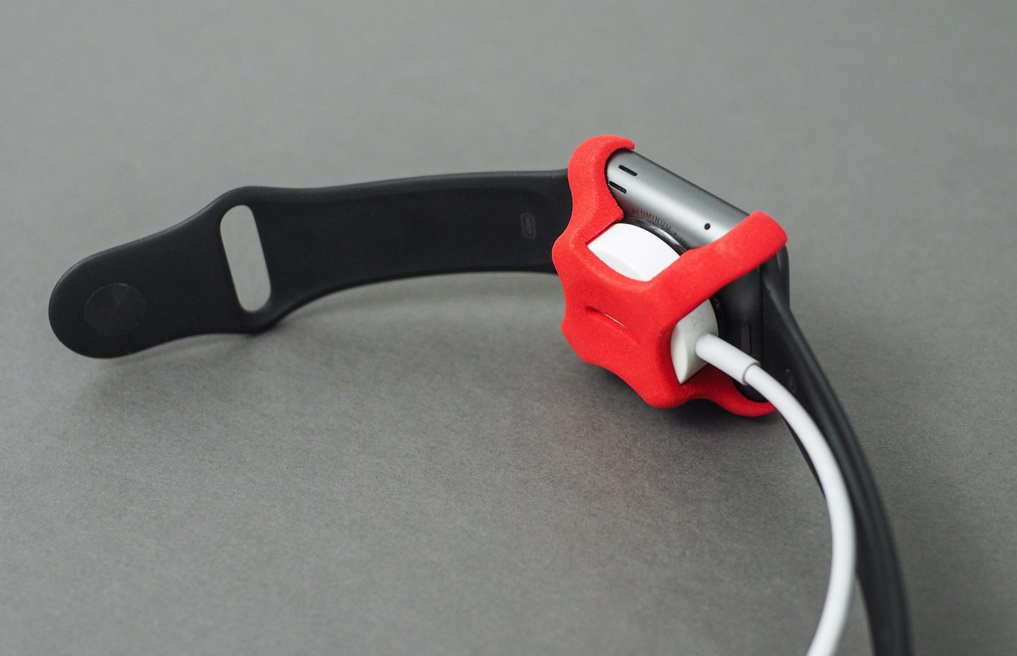 Photo of Apple Watch with charging clip. 