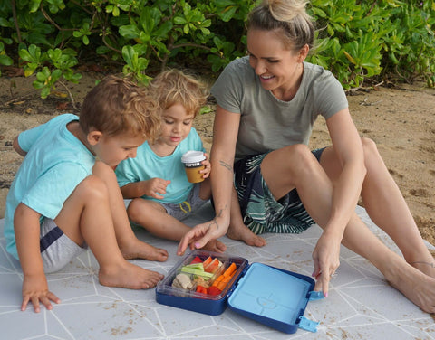 Family at the bench eating from a Jordbarn Bento Lunch Box