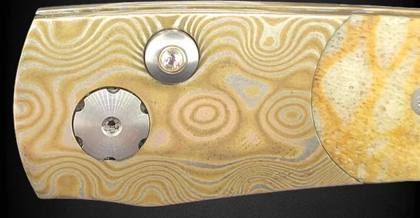 close up of mokume gane on the the frame of william henry luxury folding knife