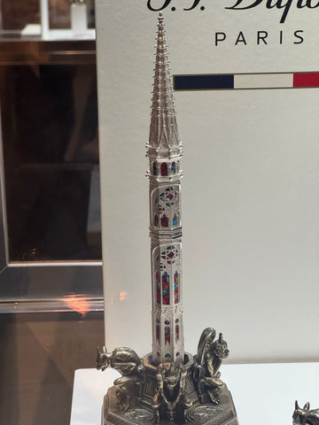 Close-up of the S.T. Dupont Notre Dame pen, designed to resemble the spire of the cathedral, adorned with colored glass-like details.