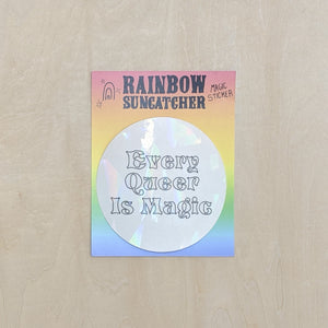Suncatcher sticker by Hills + Holler. Round sticker appears pearlescent white and reads "every queer is magic" in handwritten block letters. Sticker is on a rainbow background. available at Coyote Supply Co, a zero waste witch store in Midtown Reno, Nevada that is BIPOC owned