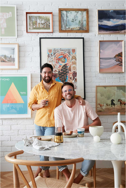 Jono Fleming and partner Ryan Thomas Mcgregor at home art wall in kitchen Interior Designer and Stylist