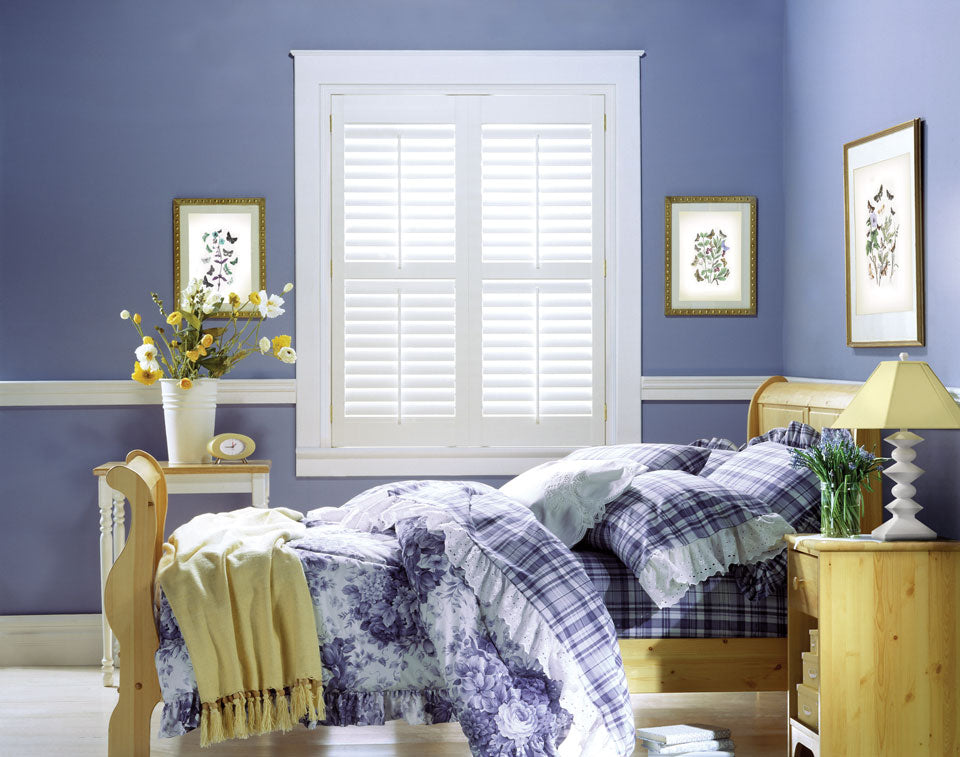Hunter Douglas Palm Beach Shutters in a purple bedroom. Available at JC Licht in Chicago