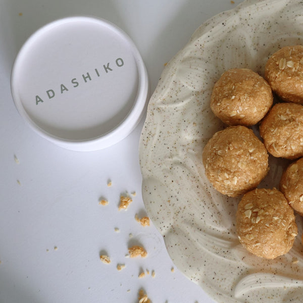 Overhead view of a plate of ANZAC Collagen Bliss Balls next to a tub of Adashiko Pure Collagen Powder | Adashiko Collagen | 100% Natural Skincare