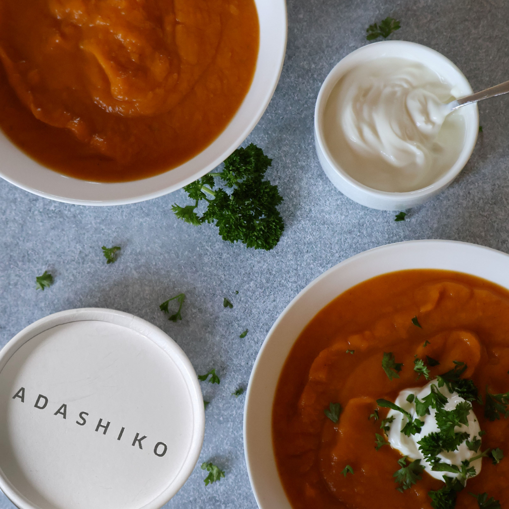 Two bowls of Pumpkin + Kumara Collagen Soup next to a tub of Collagen Pure | Adashiko Collagen | 100% Natural Skincare