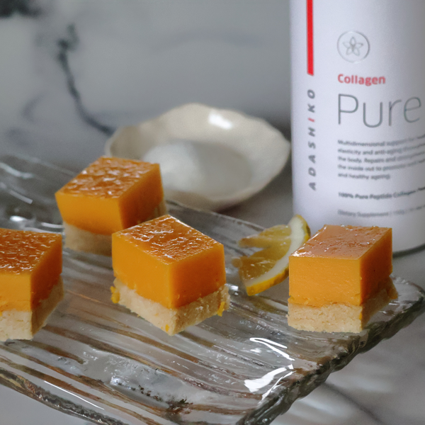 Four slices of Lemon Curd Collagen Slice next to a tub of Collagen Pure | Adashiko Collagen | 100% Natural Skincare