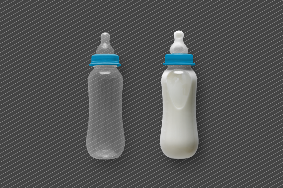 Two milk bottles. One is empty and one is filled with milk.