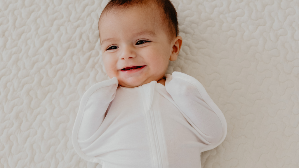 baby in a swaddle smiling